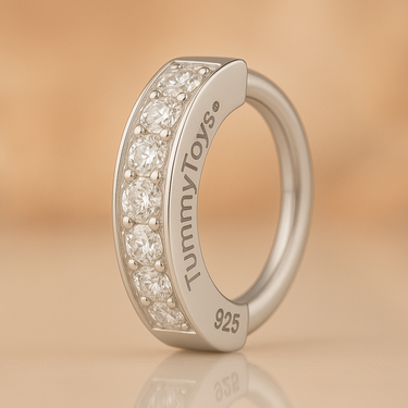 Silver ring with diamonds on a beige background, featuring the brand 'TummyToys'.