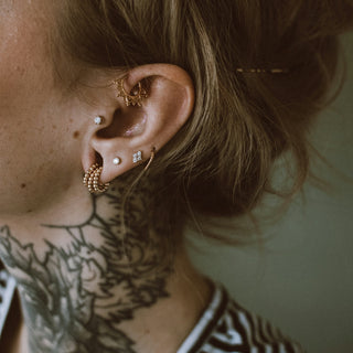 a woman with a tattoo on her ear