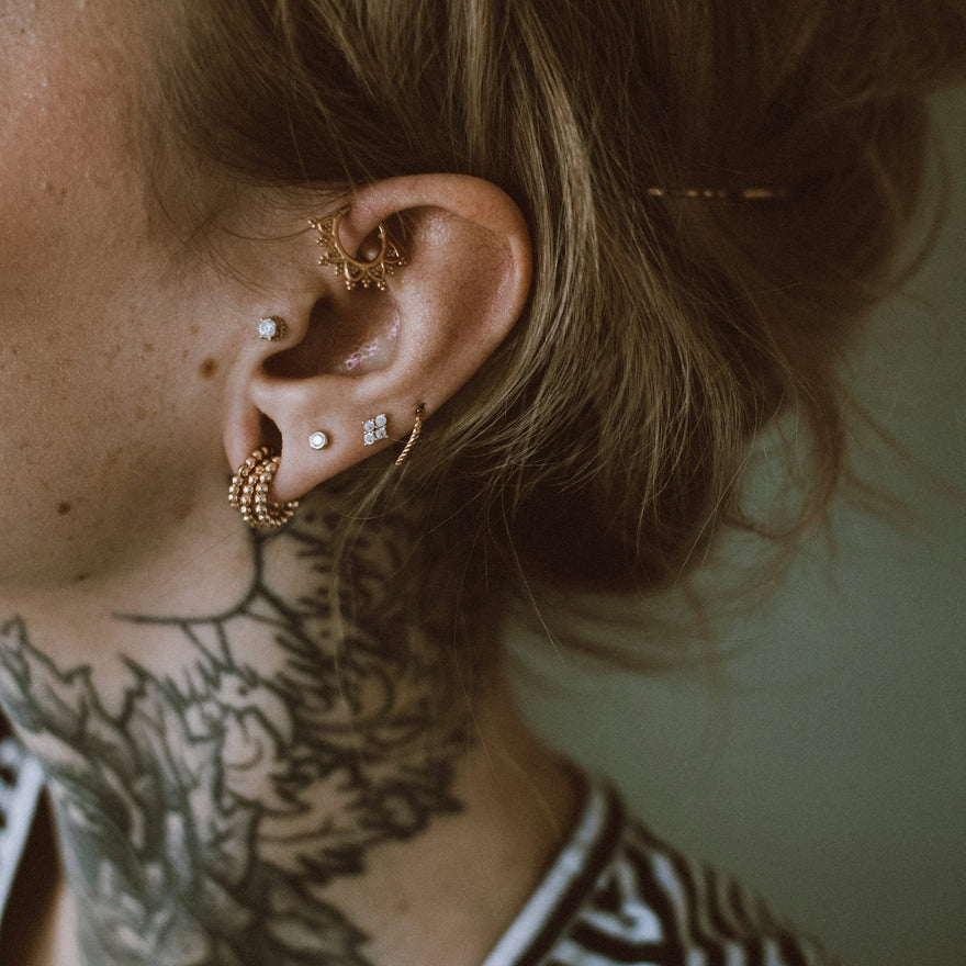 a woman with a tattoo on her ear