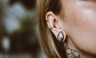a woman with a tattoo on her ear