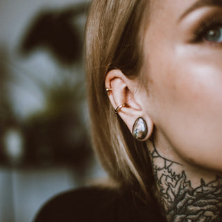 a woman with a tattoo on her ear