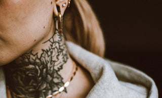 a woman with a tattoo on her neck