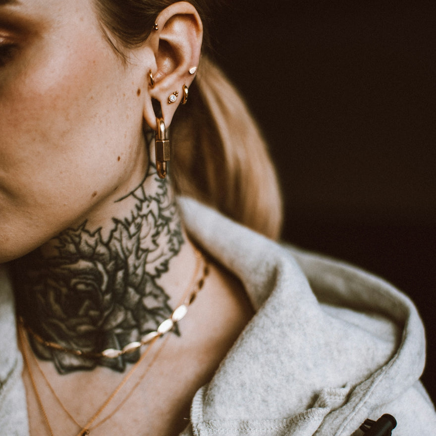 a woman with a tattoo on her neck