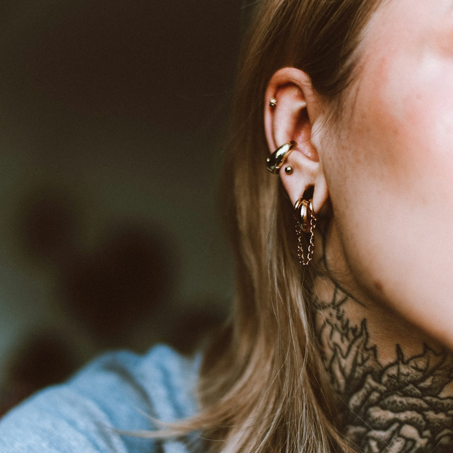 a woman with a tattoo on her neck
