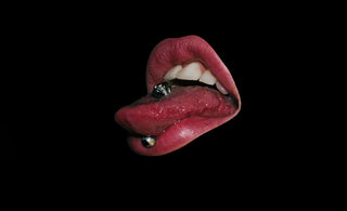 a close up of a person's mouth with a ring on it