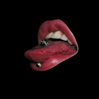 a close up of a person's mouth with a ring on it