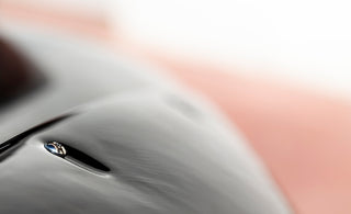 A close up of a water drop with a blurry background