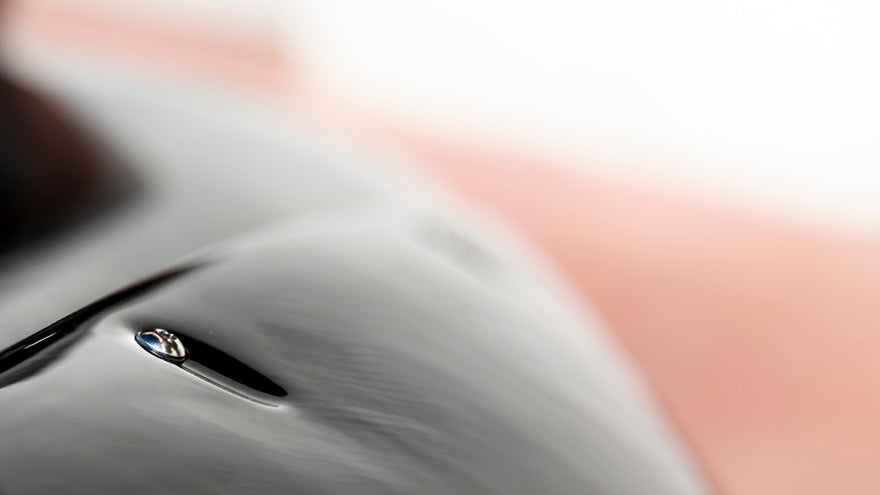 A close up of a water drop with a blurry background