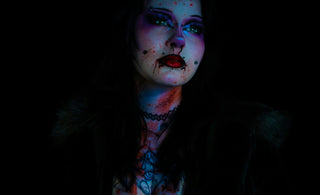 Woman with dramatic makeup and dark attire