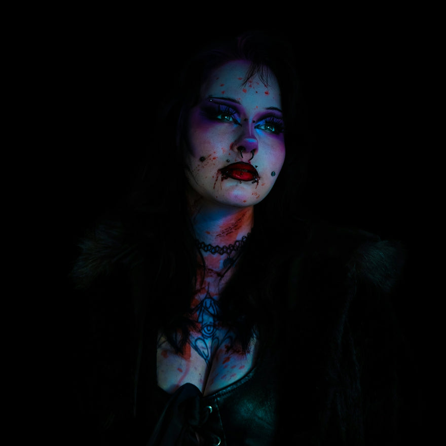 Woman with dramatic makeup and dark attire