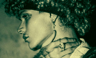 Man with curly hair and tattoos