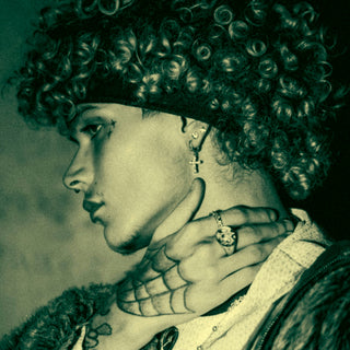 Man with curly hair and tattoos