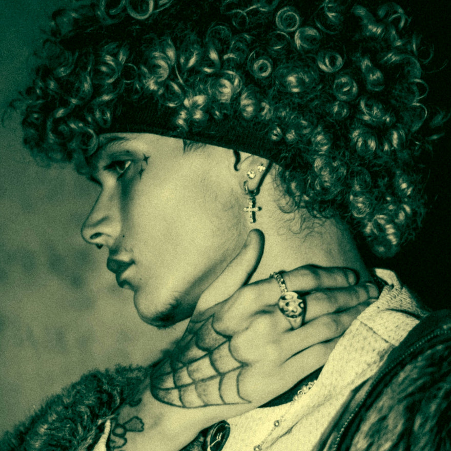 Man with curly hair and tattoos