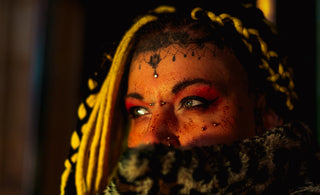 Woman with blonde braids and facial piercings