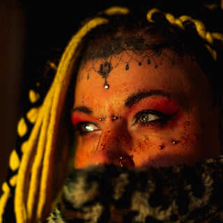Woman with blonde braids and facial piercings