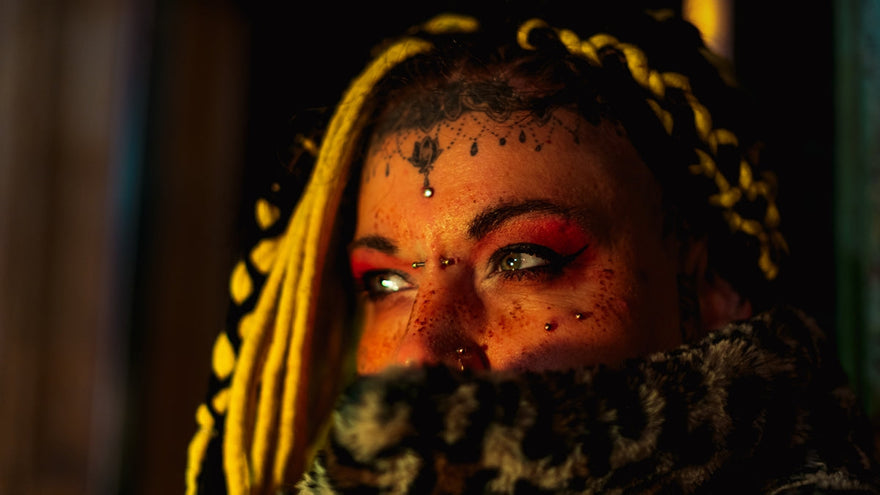 Woman with blonde braids and facial piercings