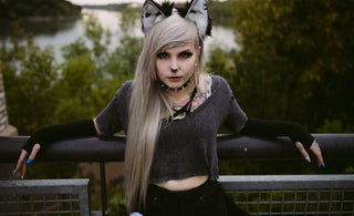 Young woman with wolf ears and grey hair outdoors